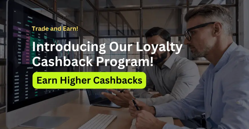 Two people are sitting at a desk with computers, analyzing data on the screens. Text on the images says "Trade and Earn. Introducing Our Loyalty Cashback Program! Earn Higher Cashbacks"